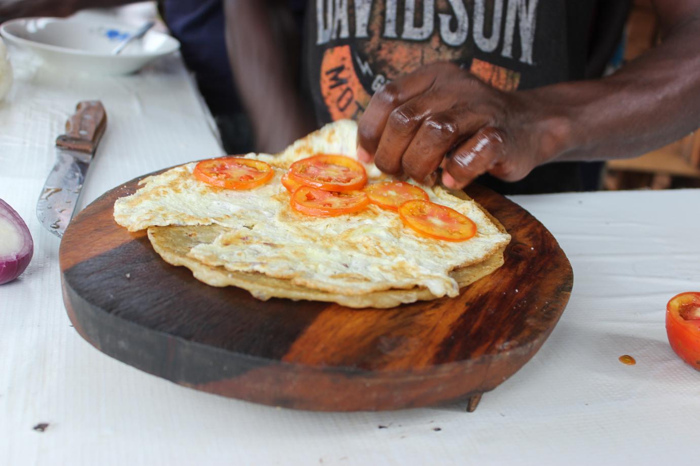 Making of a Rolex, a special food of rolled eggs, sold on streets of Uganda